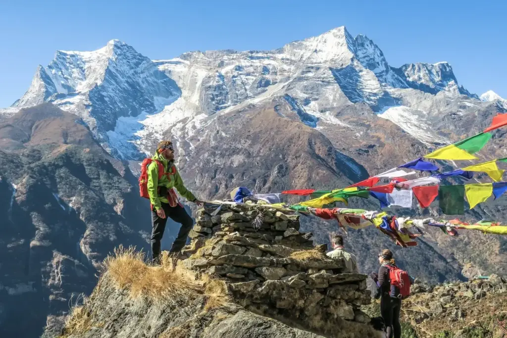 Trekkers standing on the rock with beautiful view od mountain on the back: best trekking holidays in Nepal