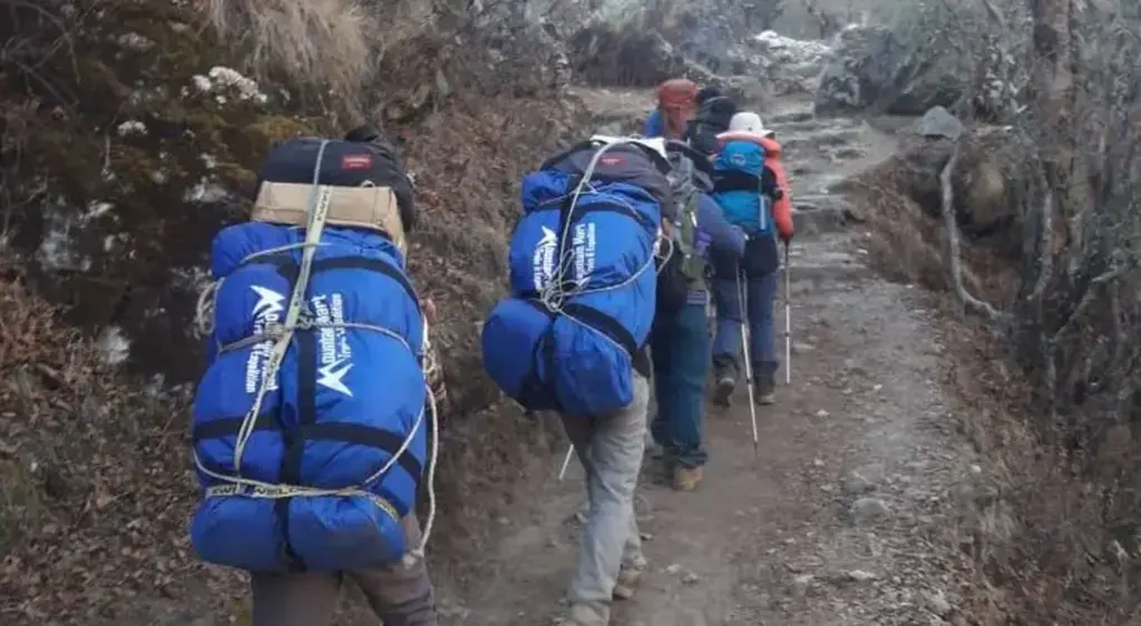 Porters carrying trekkers bag - trekking packing bag