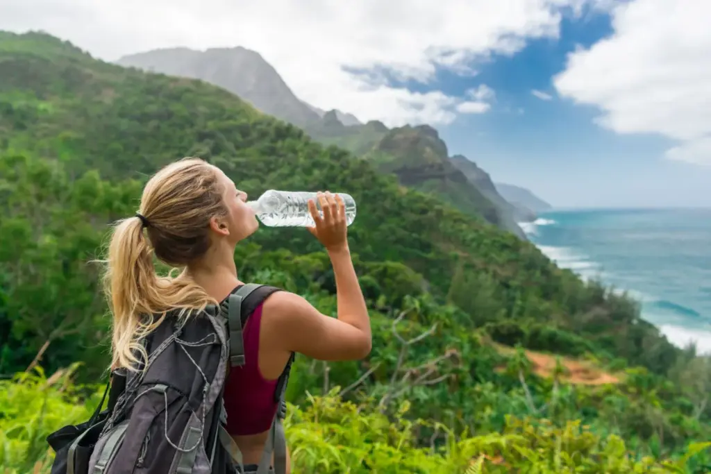 A women drinking clean water while hiking