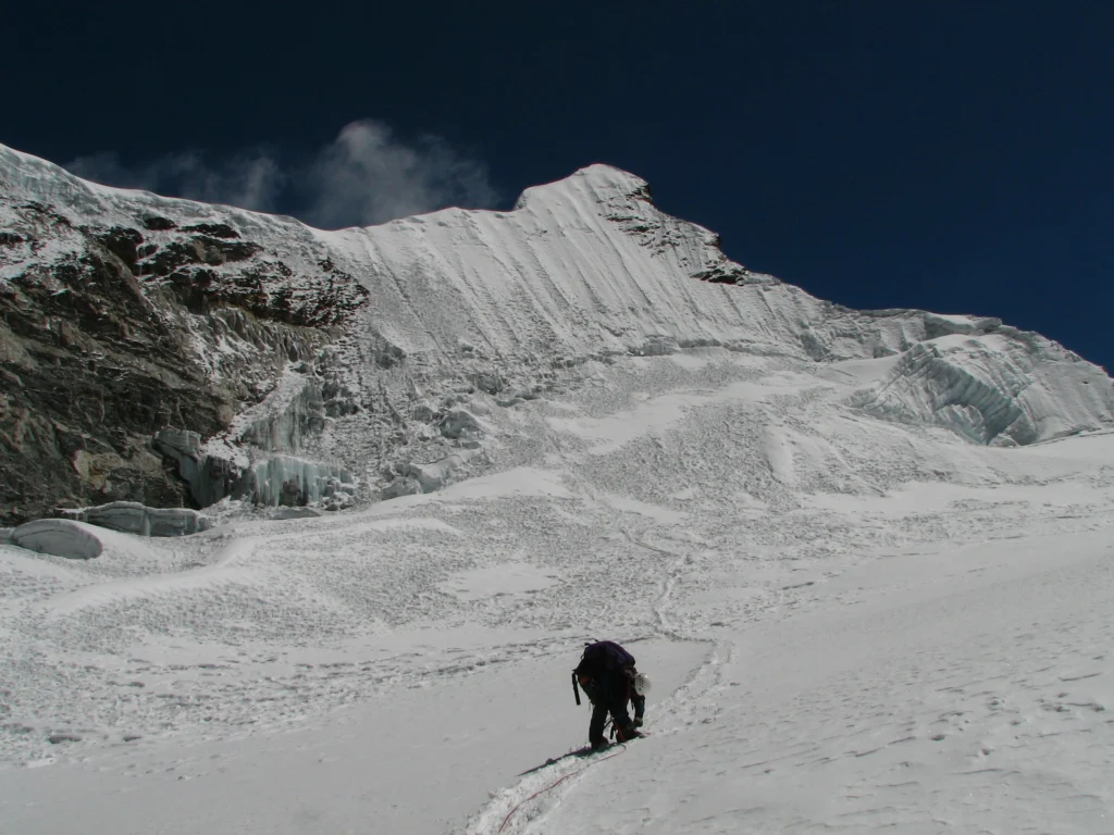 A climber summiting the island peak