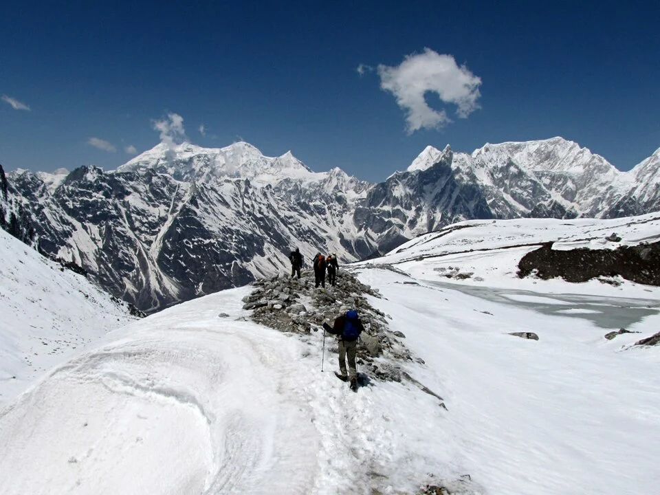 Trekkers crossing larkye la pass Manaslu Circuit Trek in winter