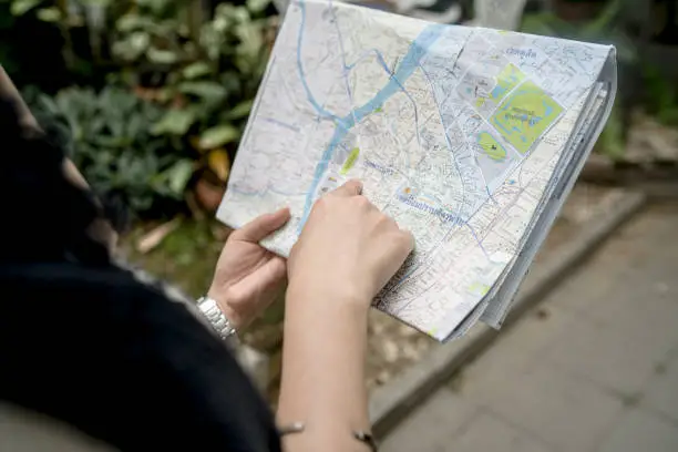 A woman carrying a map