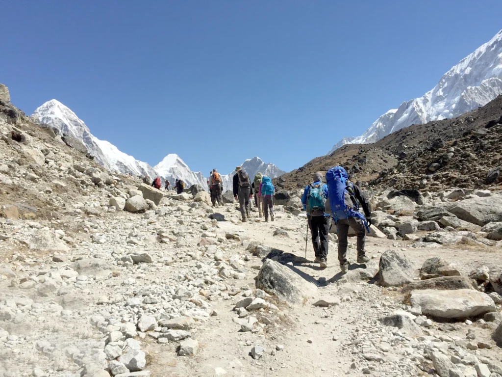 Hikers trekking through high-altitude Himalayan terrain in Nepal