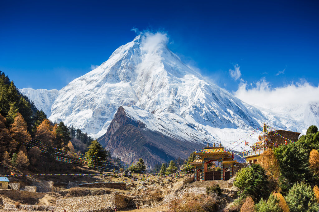 Mountain landscape in Manaslu circuit with snowy mountain and green valley